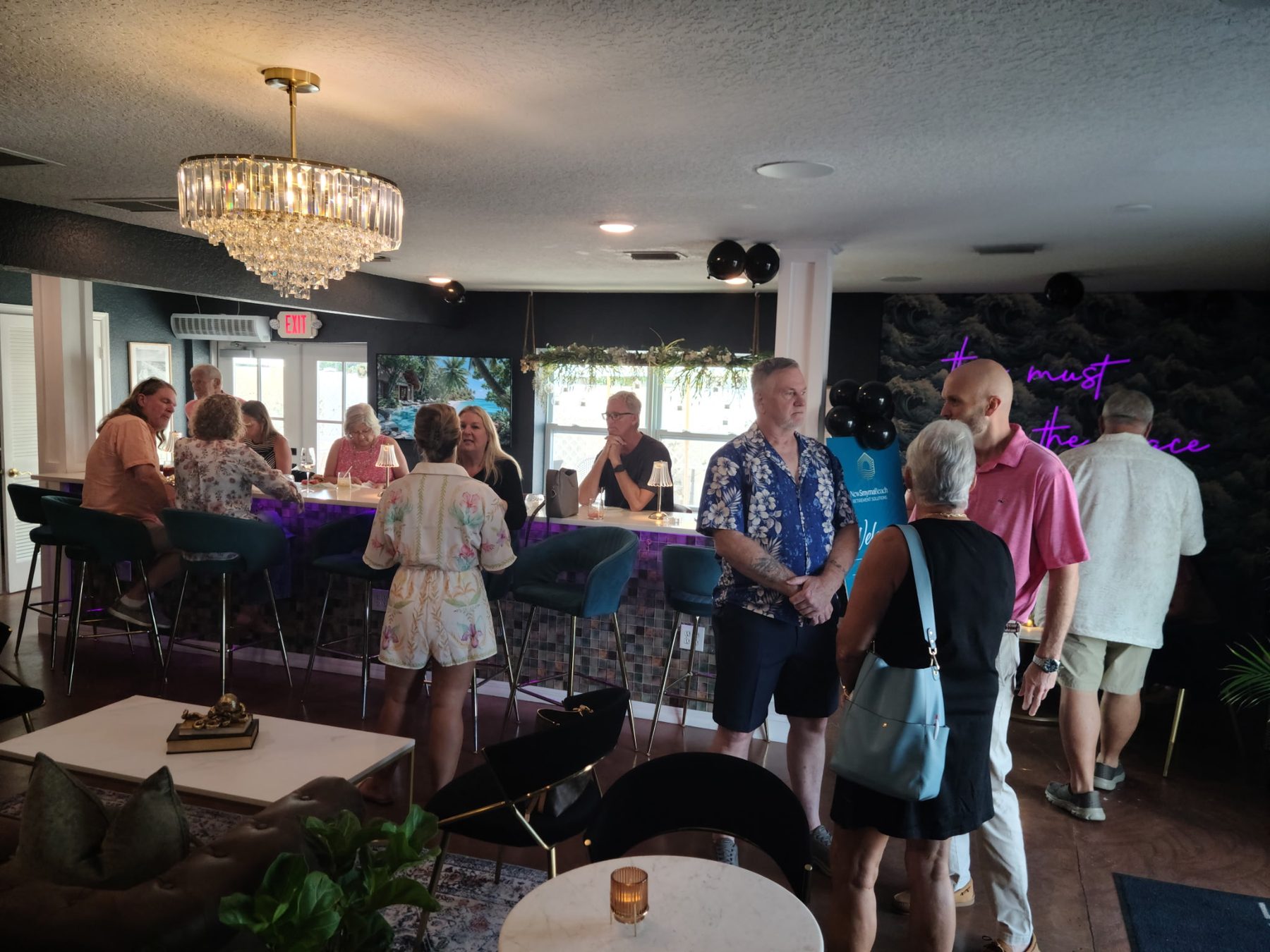 Guests gathering at the bar during the client appreciation dinner