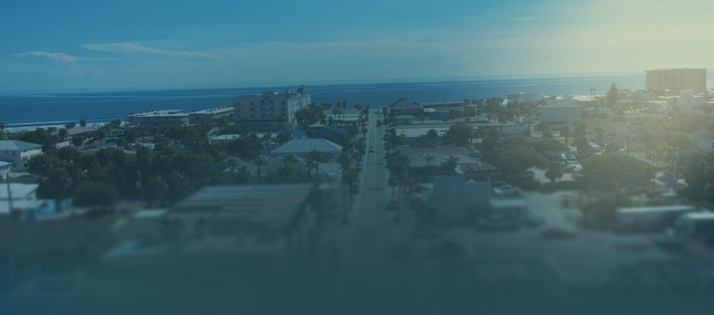 Aerial view of a beachside neighborhood in New Smyrna Beach, Florida, looking east toward the Atlantic Ocean